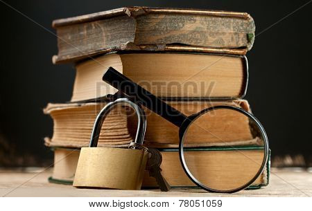Old Books With Keylock And Magnifying Glass