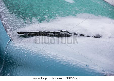 Frozen Wiper Of The Car With Icicles, Ice And Frost