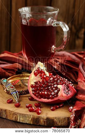 Peeled Pomegranate, Glass Of Pomegranate Juice And Jewerly On Wooden Board