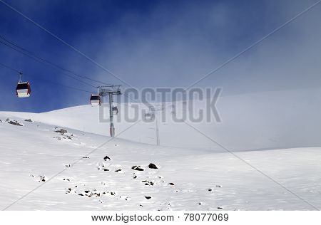 Gondola Lifts And Ski Slope In Mist