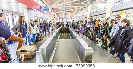 People Wait At Baggage Belt  In  Tegel Airport