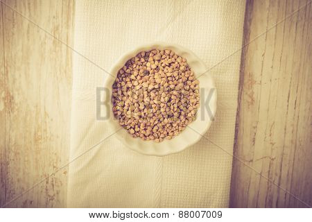Buckwheat Grains In White Bowl. Studio Shot With Vintge Mood