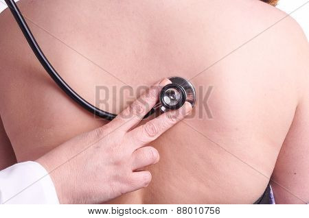 Young Woman Being Exam For Pneumonia By Her Family Doctor