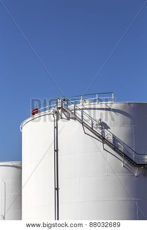 White Tanks In Tank Farm With Iron Staircase