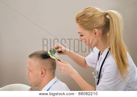 Female Dermatologist Looking Hair Through Magnifying Glass