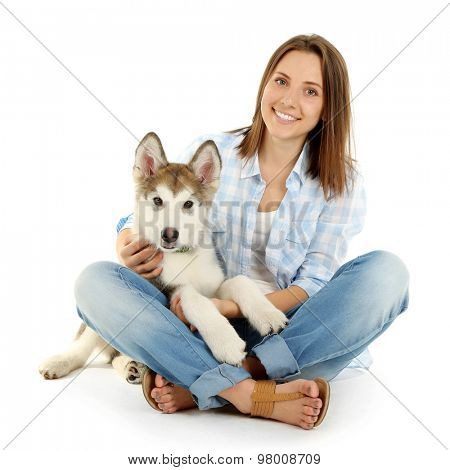 Young woman with malamute puppy isolated on white
