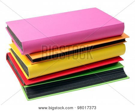The Pile Of Colored Photo Albums On Wite Backround
