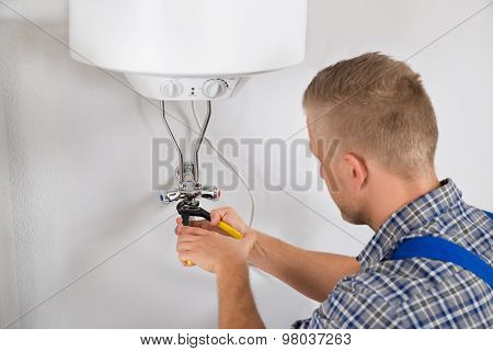 Repairman Repairing Electric Boiler