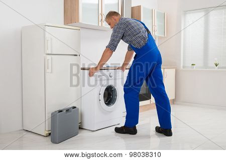 Worker Repairing Washer