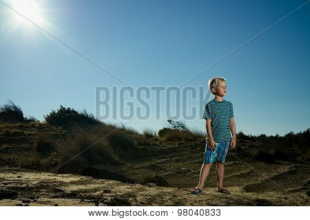 Boy In The Arid Desert Sun