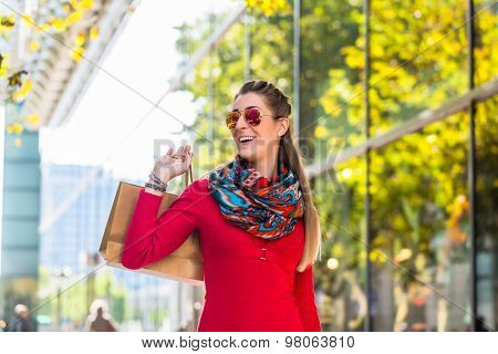 Girl walking down the street with shopping bags
