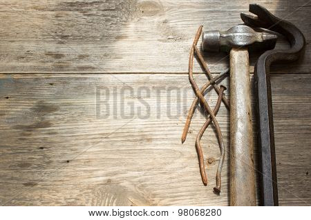 Old Rusty Nails And Hammer, Nail Puller On Wooden Background, Space For Text