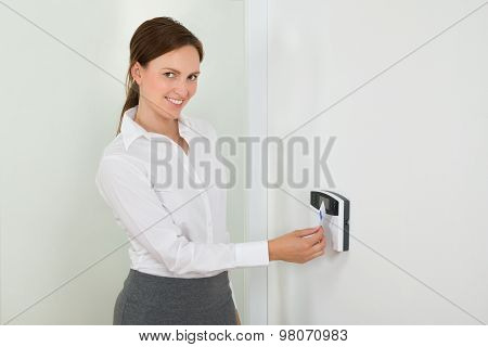 Businesswoman Inserting Keycard In Security System