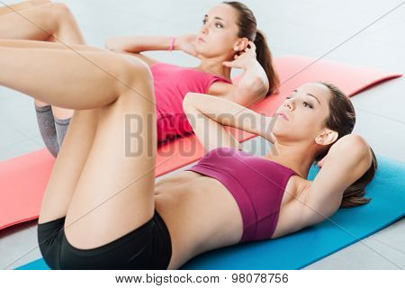 Young Women Doing Abs Workout At The Gym