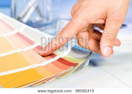 Artist Hand Pointing With Finger To Color Samples In Palette