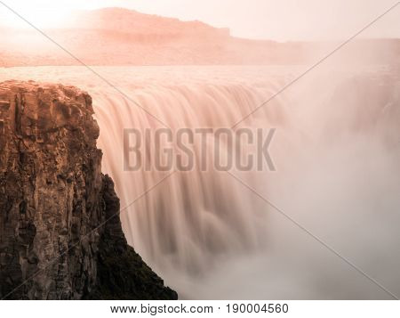 Detifoss waterfall illuminated by sunset, northern Iceland. Silk water effect by long exposure time.