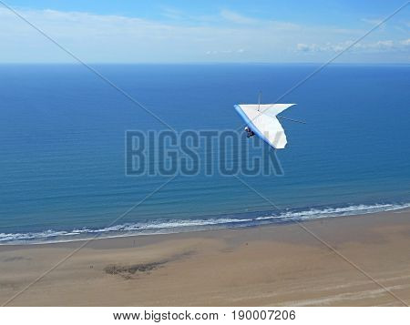 Hang Glider flying above Rhossili beach in Wales
