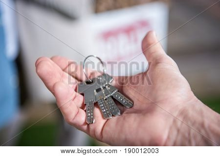 Cropped View Of Saleman Holding Keys Of New House, House For Sale Concept
