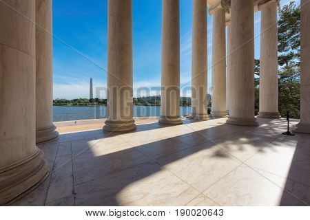Sun shining through columns at the Jefferson Memorial in Washington DC