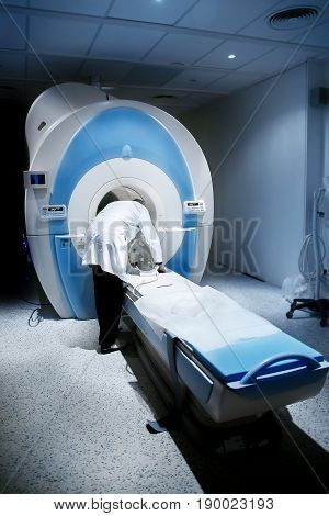 Radiologist in the room, magnetic resonance therapy in the hospital. Concept diagnosis cancer disease.