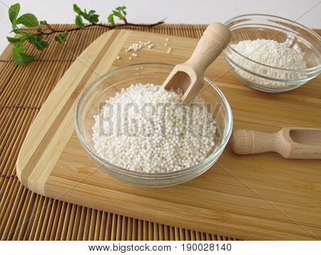 Tapioca sago pearl in bowl on wooden board