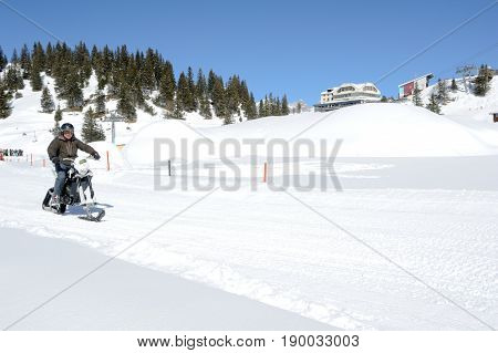 Men On Snowmobile At Engelberg On The Swiss Alps