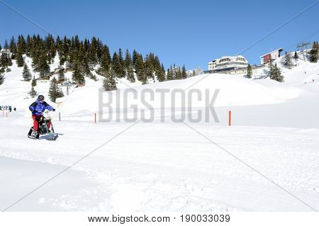 Men On Snowmobile At Engelberg On The Swiss Alps