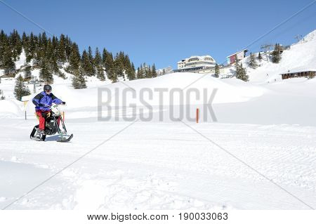 Men On Snowmobile At Engelberg On The Swiss Alps