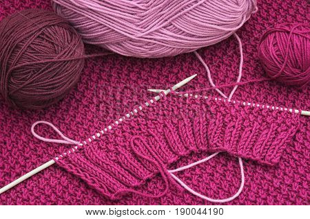 The balls of wool and knitting needles