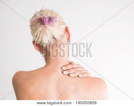 Young woman with nape pain hold her nape