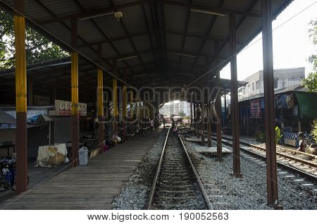 Asian thai people and travelers waiting train at Mae klong Railway station for passenger train go to Ban Leam on April 12, 2017 in Samut Songkhram, Thailand