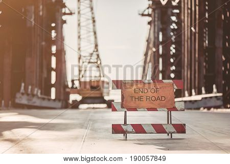View on unfinished construction on the street. Warning about the end of the road.