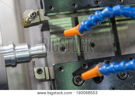 The CNC lathe machine or Turning machine cutting the metal rod with the lathe tool .The hi-technology machining concept.
