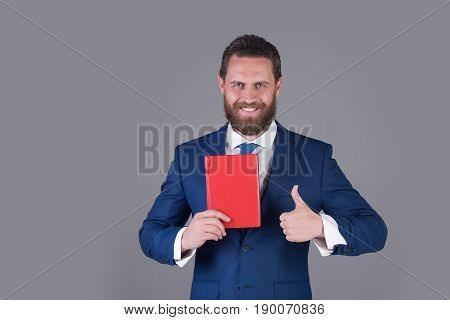 business and success reading and writing finance and accounting happy man with red book and thumb up gesture