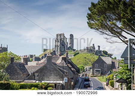 CORFE CASTLE, UK - 1st JUNE, 2017: Village of Corfe and ruins of Corfe Castle, in Swanage, Dorset, Southern England 