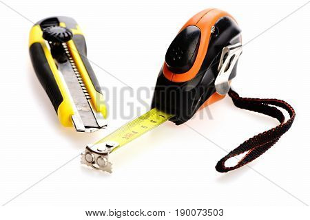 Tape Measure And Utility Knife Isolated On White Background