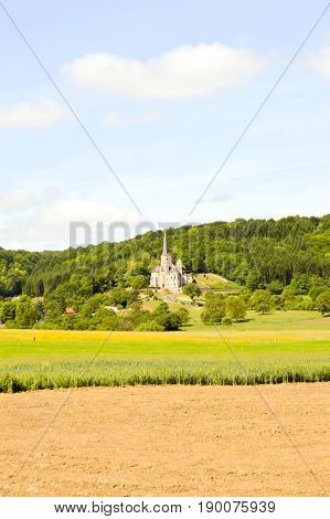 Cultures and church of Notre-Dame de Mont-Devant-Sassey in the department of the Meuse