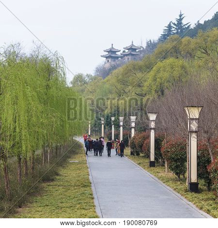 Tourists Walk To Temples In Longmen Grottoes