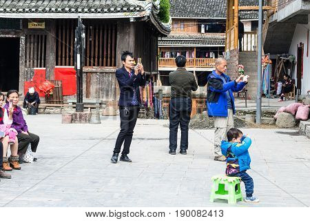 Tourists Take Photos Of Dong Culture Show