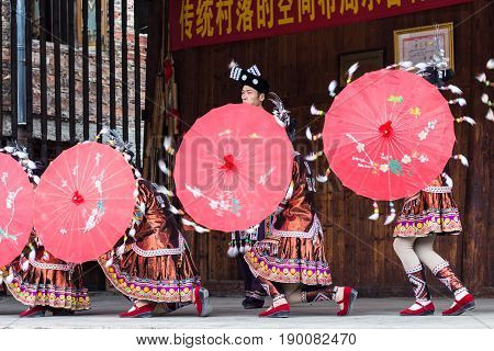 Folk Dancers With Umbrellas In Dong Culture Show