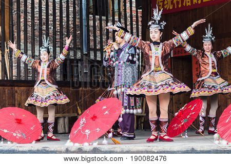 Folk Players With Umbrellas In Dong Culture Show