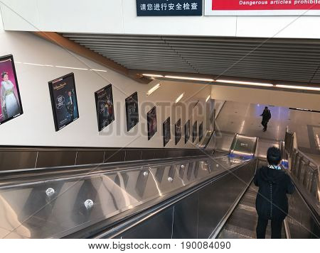 People On Moving Staircase In Beijing Subway