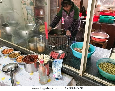 Chief Cooks Food In Cheap Urban Eatery