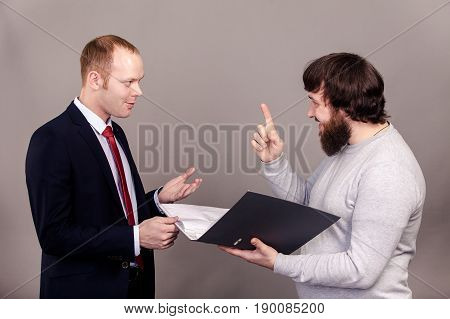 Business negotiations. Salesman and buyer discuss the contract standing in front of each other isolate on dark background.