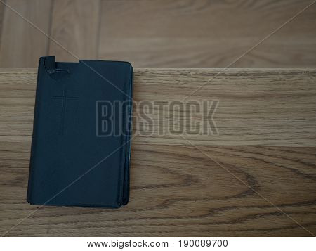Holy Bible on old wooden church table top view