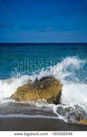 Azure sea with rock and sea foam