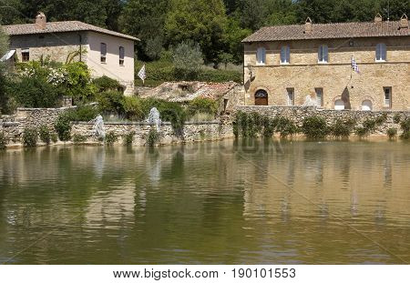 BAGNO VIGNONI, ITALY - JUNE 3 2017: Bagno Vignoni medieval town with its square with hot spring thermal water in Tuscany Italy