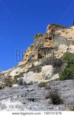 BAGNO VIGNONI, ITALY - JUNE 3 2017: Natural Hot springof Bagno Vignoni in Italy with its small cascade through nature