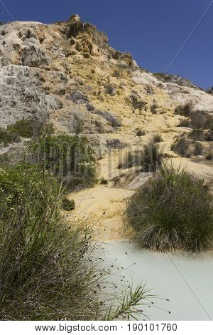 BAGNO VIGNONI, ITALY - JUNE 3 2017: The scenic hot spring pool of Bagno Vignone in Tuscany free accesible area through the nature