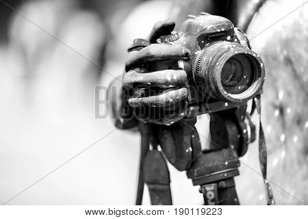Detail of dirty dslr camera. Equipment mistreat. Black and white.